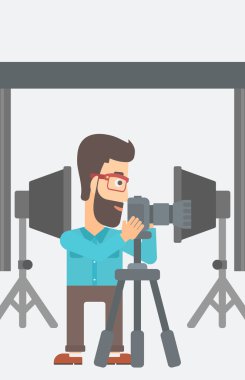 Photographer working with camera on a tripod.