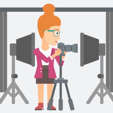 Photographer working with camera on a tripod.