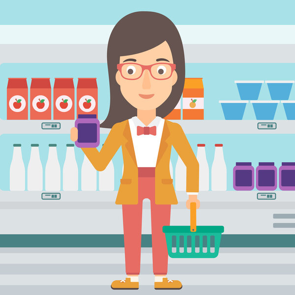 Customer with shopping basket and tube of cream.