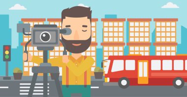 Cameraman with movie camera on a tripod.