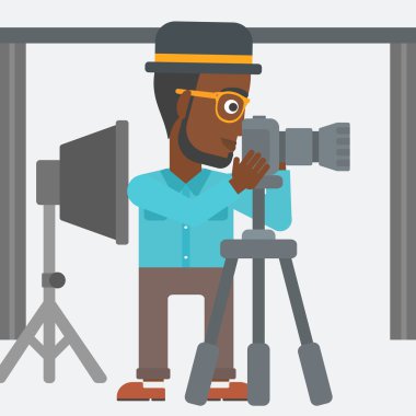 Photographer working with camera on a tripod.