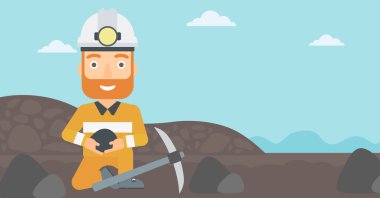 Madenci holding kömür elinde.