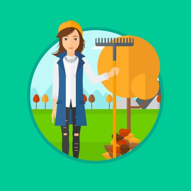 Sonbahar yapraklarını tırmıklayan kadın.