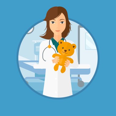 Çocuk doktoru doktor holding oyuncak ayı.