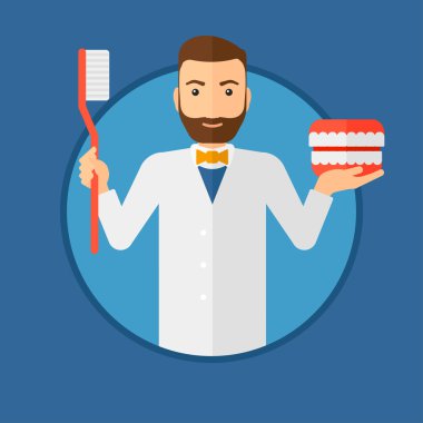 Dişçi diş çene modeli ve diş fırçası.