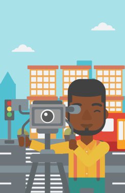 Cameraman with movie camera on a tripod.