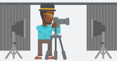 Photographer working with camera on a tripod.
