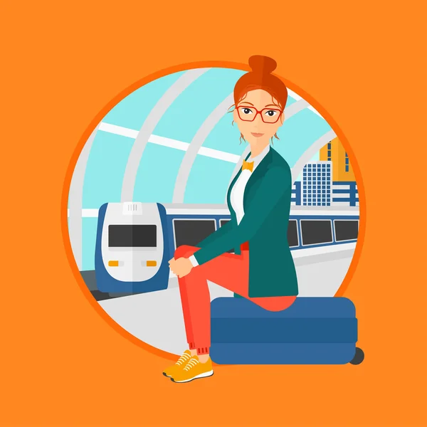 Woman sitting on suitcase at the train station. — Stock vektor