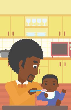 Baba bebeği besliyor.