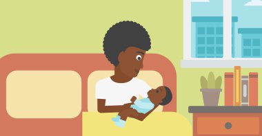 Woman with new born in maternity ward.