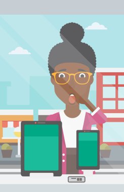 Woman looking at digital tablet and smartphone.