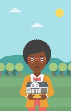 Woman holding house model vector illustration.