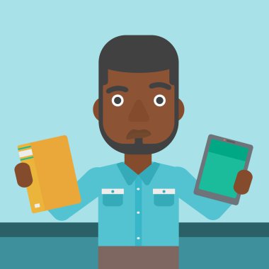 Man choosing between book and tablet computer.