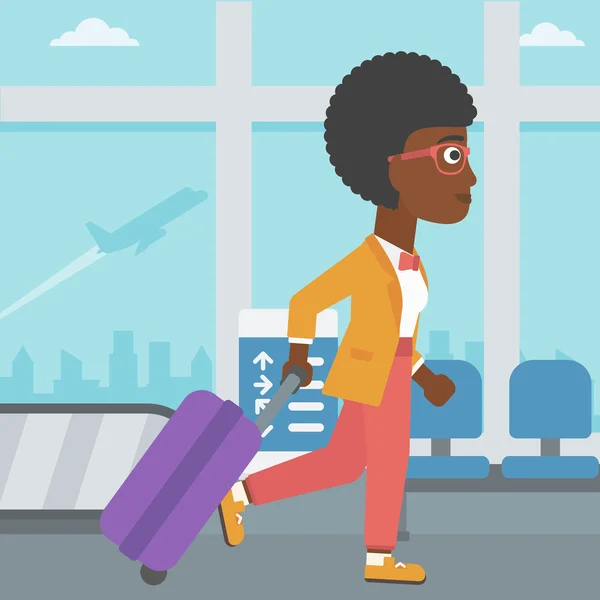 Mujer caminando con maleta en el aeropuerto . — Vector de stock