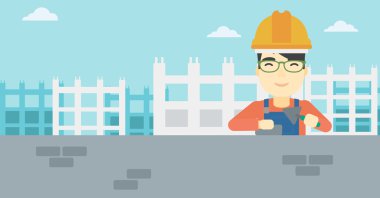 Duvarcı ustası spatula ve tuğla ile.