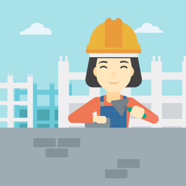 Duvarcı ustası spatula ve tuğla ile.