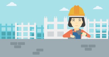 Duvarcı ustası spatula ve tuğla ile.