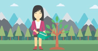 Kadın ağaç ampuller ile sulama.