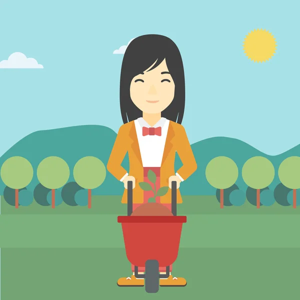 Mujer con planta y carretilla . — Vector de stock