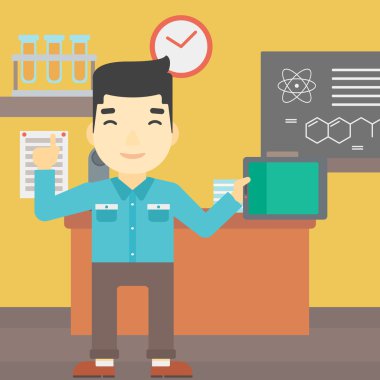 Erkek öğrenci sınıfta tablet bilgisayar kullanarak.