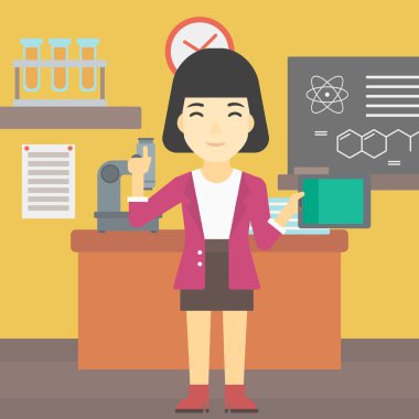 Kız öğrenci sınıfta tablet bilgisayar kullanarak.