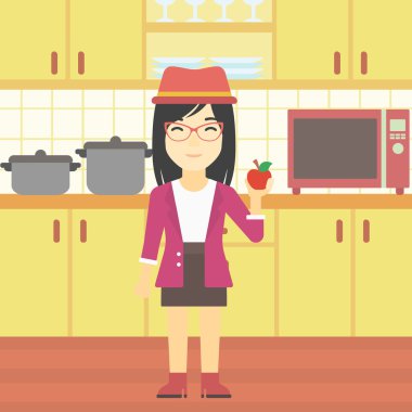 Genç kadın mutfakta apple ile.