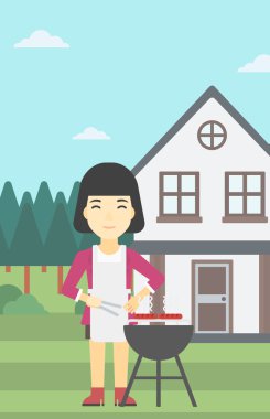 Woman cooking meat on barbecue grill.