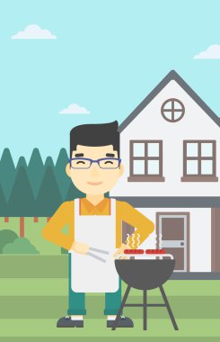 Man barbekü ızgara et pişirme.