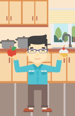 Adam elma ve cupcake arasında seçim yapma.