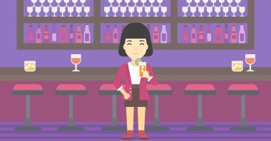 Woman drinking orange cocktail at the bar.