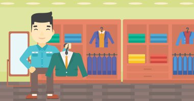 Giyim mağazasında takım elbise ceket tutan adam.