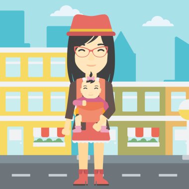 Kızını askıda taşıyan anne.