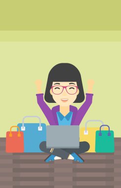 Woman shopping online using her laptop.