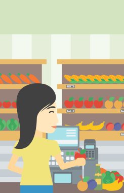 Cashier standing at the checkout in supermarket. clipart