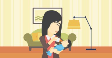 Annesi bebeğini besliyor.