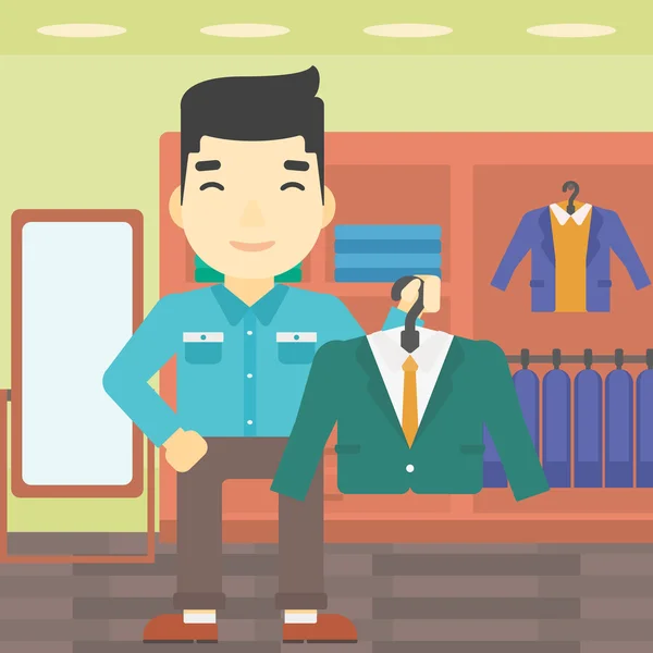 Homme tenant une veste de costume dans un magasin de vêtements . — Image vectorielle