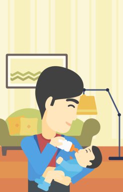 Baba bebeği besliyor.