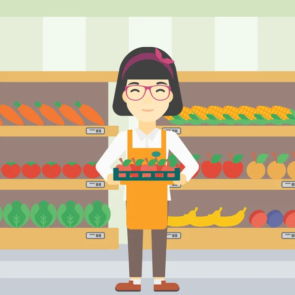 Ouvrier de supermarché avec boîte pleine de pommes . — Image vectorielle