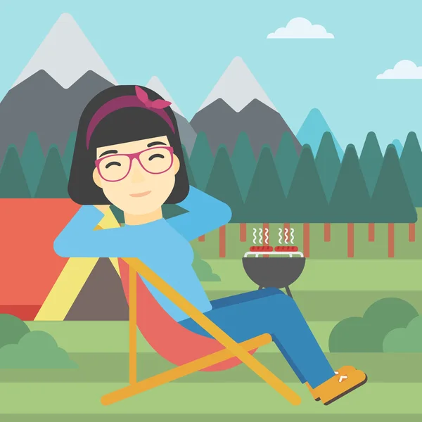 Mujer sentada en silla plegable en el campamento . — Vector de stock