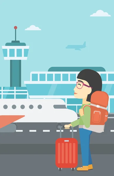 Mujer en el aeropuerto con maleta . — Vector de stock
