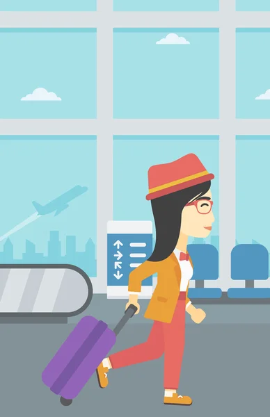 Mujer caminando con maleta en el aeropuerto . — Vector de stock