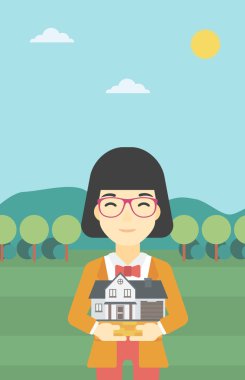 Woman holding house model vector illustration.
