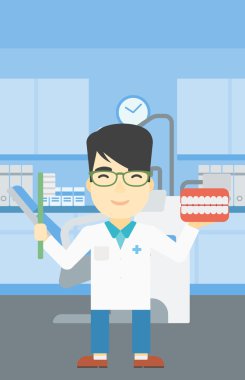 Dişçi diş çene modeli ve diş fırçası.