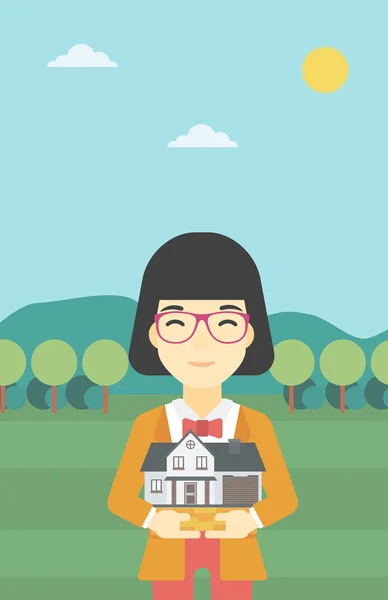 Woman holding house model vector illustration. — 스톡 벡터