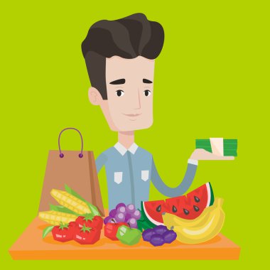 Alışveriş çantası ile masada duran genç adam