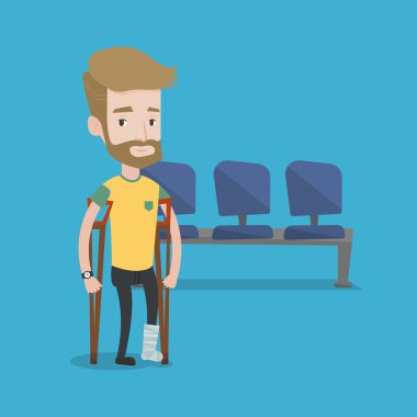 Kırık bacak ve koltuk değneği olan adam.