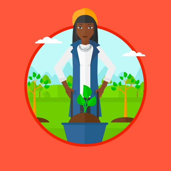 Mujer empujando carretilla con planta . — Vector de stock