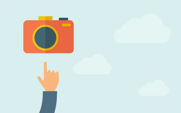 Hand pointing to a camera icon. — Stock Vector