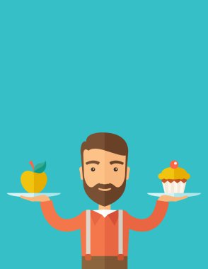 adam onun iki eli cupcake ve elma ile taşır.