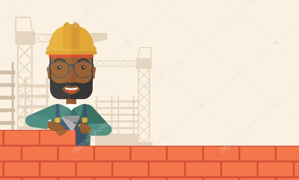 Black builder man is building a brick wall.